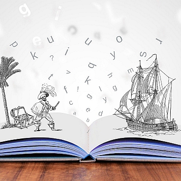 Open book on wood table with drawings of pirate and ship and letters rising out of it.